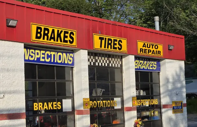 The Express Oil and Brakes shop on Epping Road in Exeter, with Brakes, Tires, Auto Repair and Inspections signs over the bays