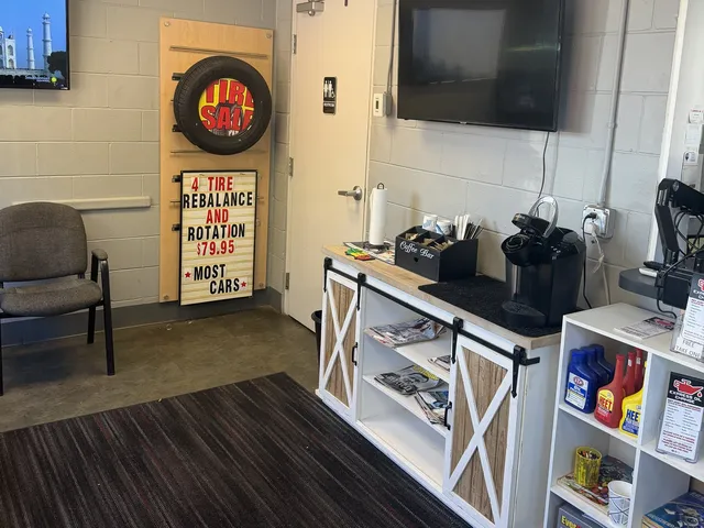 The Express Oil waiting room with the coffee bar, TV and tire specials board